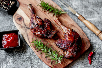 Wall Mural - grilled duck legs on a stone background