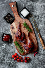 Wall Mural - grilled duck legs on a stone background