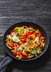 Wall Mural - chicken fajitas with bell peppers, onion, spices