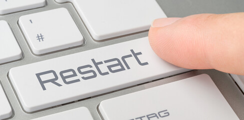 Wall Mural - a keyboard with a labeled button - restart