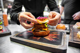 Fototapeta Kawa jest smaczna - chef hand cooking cheeseburger on restaurant kitchen
