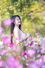 beautiful woman happy traveler walking in the flowers garden. young woman smile and relaxing with ha