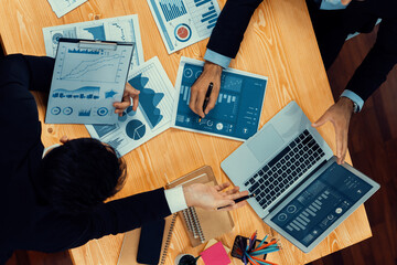 Poster - Top view analyst team discussing financial data on digital dashboard, analyzing chart and graph papers by data science software on wooden table background. Business intelligence and Fintech. Fervent