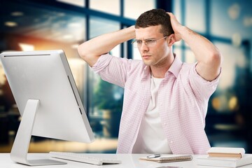 Poster - young business male working on computer