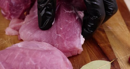 Wall Mural - Cut into pieces a piece of pork neck, a soft boneless part of pork while slicing for cooking