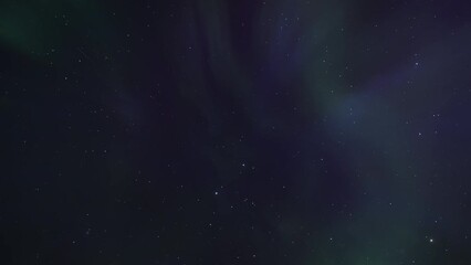 Wall Mural - Northern Lights (Aurora Borealis) appear overhead on the night sky. Timelapse. 