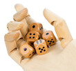 Cropped wooden robotic hand holding dices.