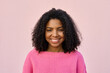 © Stock 4 You - A cheerful stylish hipster teenage female girl in pink sweater looking at camera. A portrait headshot of a young happy smiling woman with a big afro hairstyle on her head on pink soft background.