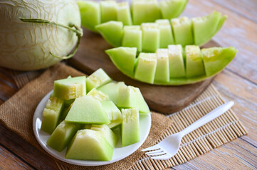 Wall Mural - cantaloupe thai slice fruit for health green cantaloupe thailand, cantaloupe melon on plate wooden