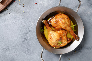 Wall Mural - Freshly roasted duck legs confit in oven pan, top view