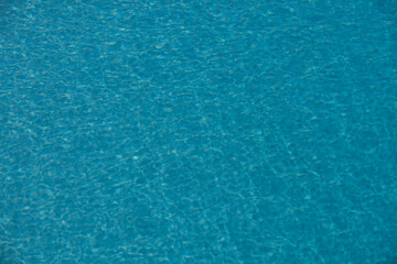 ripped water in swimming pool. surface of blue swimming pool, background of water.
