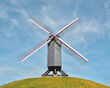 windmill on top of a hill in the fields of Bruges