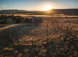 Aerial image of sun setting over cabin and livestock pen, New Mexico