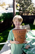 Eight Year Old Boy Holding Decorated Pot in San Diego