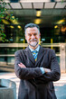 © Guillem de Balanzó - Positive adult businessman with arms crossed looking at camera