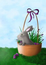 A Gray Easter Bunny Sits In A Brown Wicker Basket Filled With Flowers And Multi-colored Eggs And Decorated With A Purple Bow On Top Against The Background Of Green Grass And Blue Sky. Holiday. Easter.