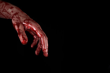 Fototapeta bloody hand on a black background, the concept of self-defense, murder, nightmares, halloween. copy space for text