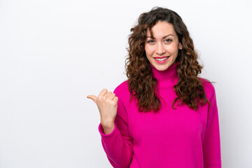 Wall Mural - Young caucasian woman isolated on white background pointing to the side to present a product