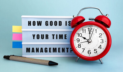 Poster - text how good is your time management written on the lightbox with alarm clock and colorfull sticker