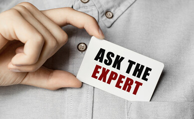 Poster - man putting a card with text ask the expert in the pocket