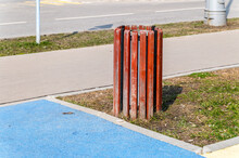 There Is A Steel Urn On The Grass, Closed In A Circle With Wooden Slats