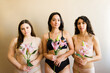 Gorgeous young women with flowers posing in their underwear