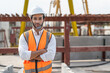 © Supachai - Portrait of male civil engineer wearing safety vest with white helmet standing arms crossed at factory making precast concrete wall for real estate housing.