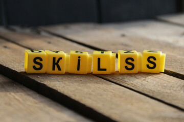 Skills. The inscription from the cubes on a vintage background.