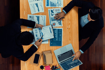 Poster - Top view analyst team discussing financial data on digital dashboard, analyzing chart and graph papers by data science software on wooden table background. Business intelligence and Fintech. Fervent