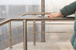 © Oleg Opryshko - woman holding on to the railing going down the stairs.