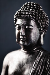 Wall Mural - Meditating Buddha Statue on dark background. Soft focus. Close up. Copy space.	