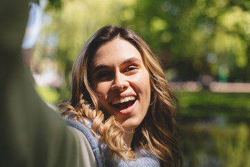 Wall Mural - Photo of nice pretty happy charming blonde curly woman summer enjoy good mood make selfie camera outdoors outside park.