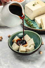 Canvas Print - soy cheese tofu diced on a light background, Healthy vegan meatless meal rich in protein and calcium. Food recipe background. Close up