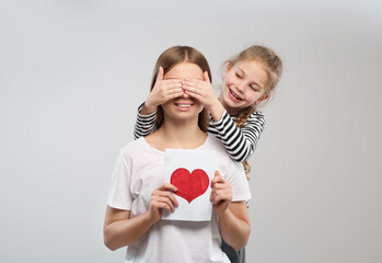 Sticker - Little daughter congratulating her mom with postcard on white background. Happy Mother's Day