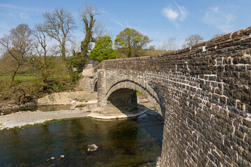 Wall Mural - A stone bridge over the Rawthey River in Sedbergh. Yorkshire, UK.