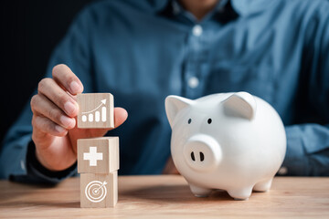 Businessman saving money in piggy bank to invest in life insurance and savings insurance. for the safety and growth of money in the future.