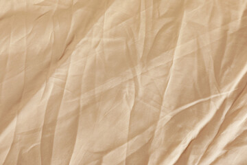 Crumpled beige fabric as background, top view