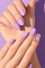 Wall Mural - Womans hands with fashionable purple manicure. Spring summer nail design