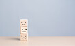 © RerF - Feedback rating concept. Customer service experience feedback emotion and satisfaction survey. Wooden cube with smiley, normal and sad face icon. Client show Neutral or Negative facial expressions.