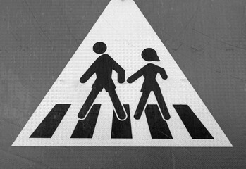 black and white pedestrian crossing sign