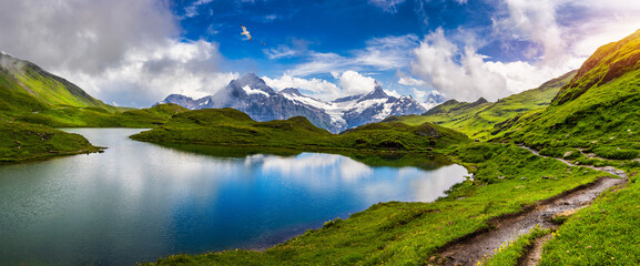 bachalpsee lake at dawn, bernese oberland, switzerland. alpine view of the mt. schreckhorn and wette