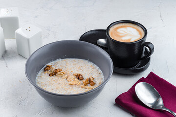 Poster - English breakfast oatmeal with walnuts, peanuts and cup of coffee.