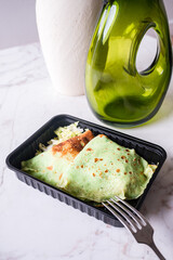 Poster - Hot green thin pancakes of spinach with coleslaw in plastic box.