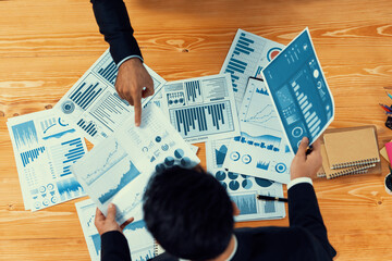 Poster - Top view analyst team discussing financial data on digital dashboard, analyzing chart and graph papers by data science software on wooden table background. Business intelligence and Fintech. Fervent