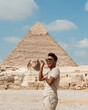 tourist and the sphinx in giza pyramids cairo egypt