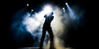 Silhouette of a Singer Musician Person on Concert. Flashlight, Smoke on Stage. Dramatic Music Performance Background. 
