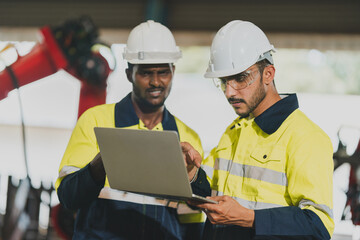 Sticker - Professional engineer holding robot controller checking and repairing automatic robotic machine at industrial factory, Technician worker working with robotic arm system for manufacturing production