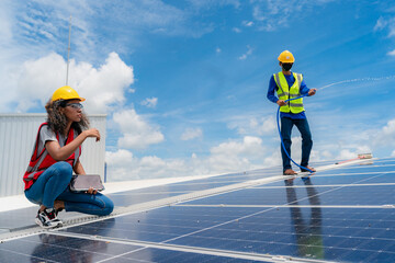 Wall Mural - Professional worker cleaning solar panels with brush and washing with water on roof structure of building factory. Technician using mop to clean the dirty and dust, green electricity energy technology