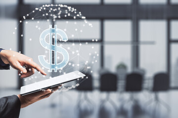 Wall Mural - Close up of businessman hand pointing at tablet with glowing dollar sign inside polygonal sphere on blurry office interior background. World currency and technology concept. Double exposure.