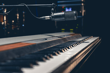 Wall Mural - Music keys and a microphone on a dark background.